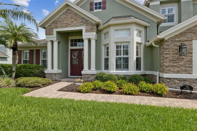 724 Duff Dr, Winter Garden, FL 34787 - doorway to property with stone siding and stucco siding