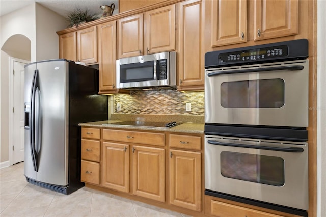 724 Duff Dr, Winter Garden, FL 34787 - kitchen featuring stainless steel appliances, light tile patterned floors, decorative backsplash, and light stone countertops