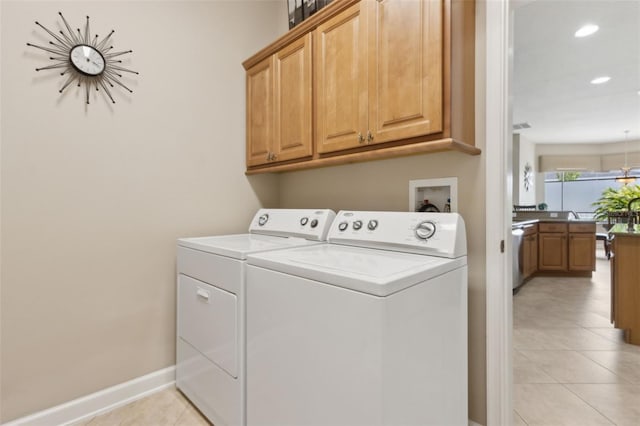 724 Duff Dr, Winter Garden, FL 34787 - laundry area featuring washer and dryer, cabinet space, light tile patterned flooring, recessed lighting, and baseboards