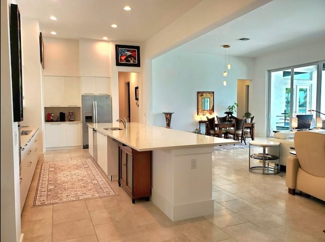 14835 Dockside Ln, Naples, FL 34114 - kitchen featuring a sink, recessed lighting, stainless steel fridge with ice dispenser, light tile patterned floors, and white cabinetry