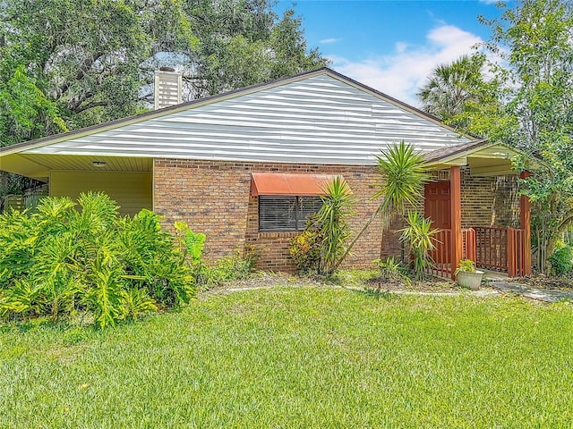 1591 Revere Ln, Daytona Beach, FL 32117 - view of property exterior featuring a lawn, brick siding, and a chimney