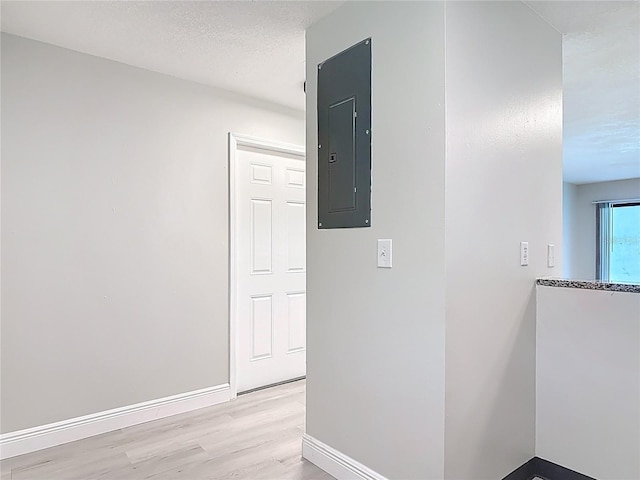 1591 Revere Ln, Daytona Beach, FL 32117 - hallway with electric panel, light wood-type flooring, and baseboards