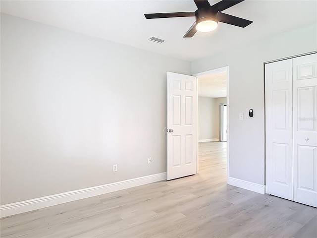 1591 Revere Ln, Daytona Beach, FL 32117 - unfurnished bedroom featuring light wood finished floors, baseboards, a closet, and a ceiling fan