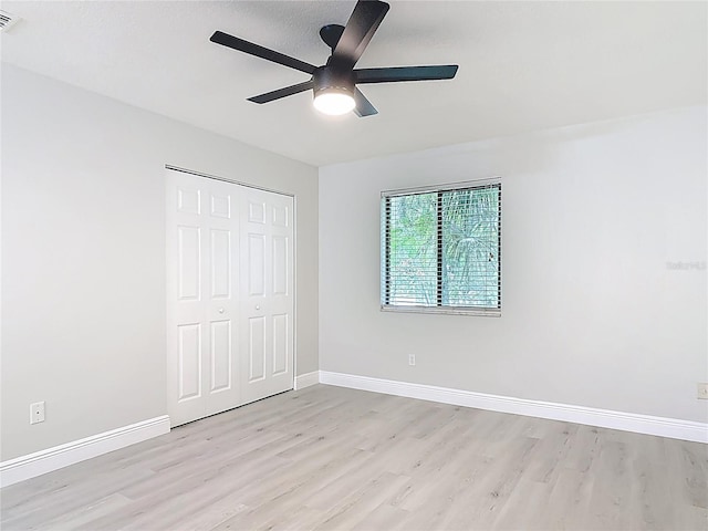 1591 Revere Ln, Daytona Beach, FL 32117 - unfurnished bedroom with light wood-type flooring, a closet, baseboards, and a ceiling fan