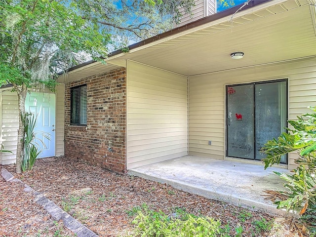 1591 Revere Ln, Daytona Beach, FL 32117 - property entrance featuring a patio and brick siding