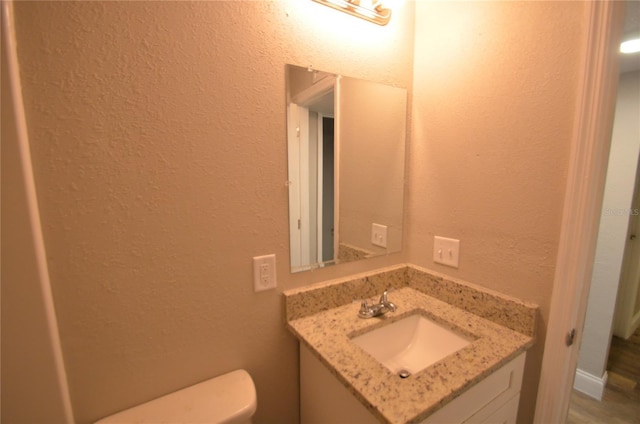 1238 Conley St, Orlando, FL 32805 - bathroom featuring a textured wall, vanity, and toilet