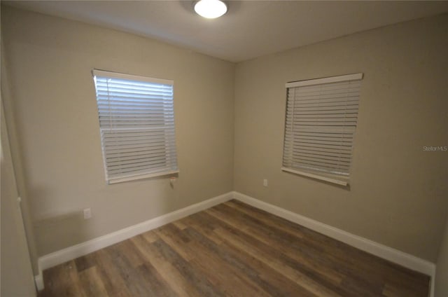 1238 Conley St, Orlando, FL 32805 - spare room with dark wood-style floors and baseboards