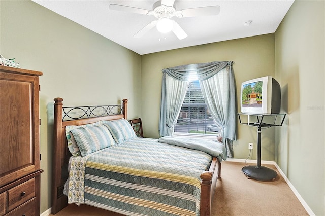 carpeted bedroom featuring baseboards and ceiling fan