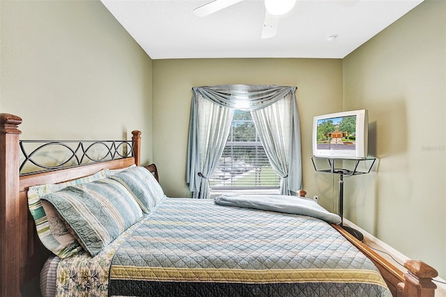 bedroom featuring a ceiling fan and baseboards