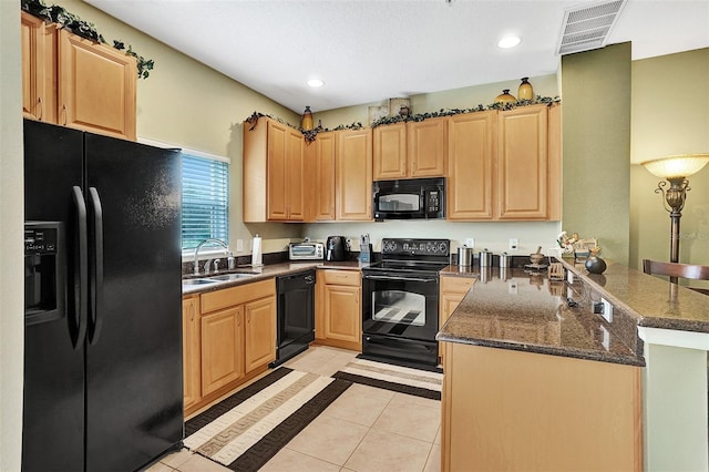 kitchen featuring black appliances, a sink, a peninsula, light brown cabinets, and recessed lighting