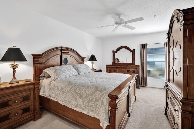 bedroom with light colored carpet, a ceiling fan, and a textured ceiling