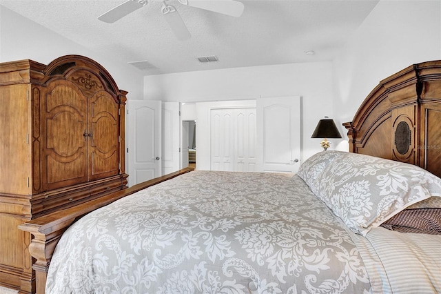 carpeted bedroom with a closet, ceiling fan, and a textured ceiling