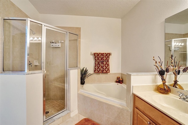 bathroom with a shower stall, a bath, tile patterned flooring, vanity, and a textured ceiling