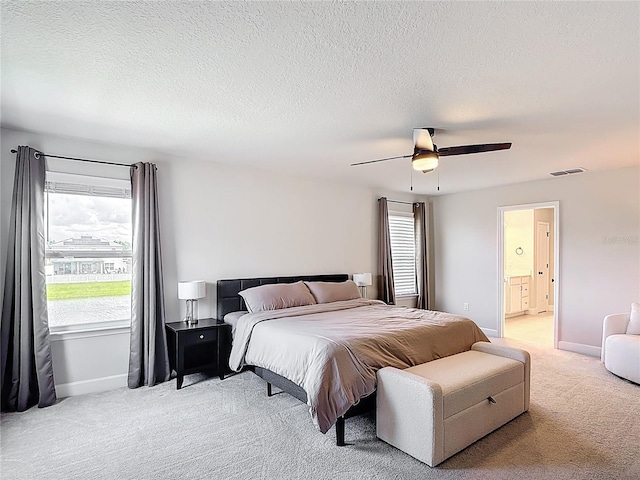 2943 Slough Creek Dr, Kissimmee, FL 34744 - bedroom with light carpet, multiple windows, baseboards, a textured ceiling, and ceiling fan