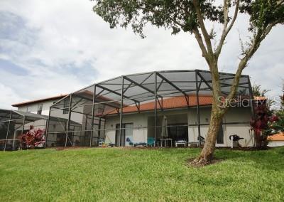 446 Summer Place Loop, Clermont, FL 34714 - back of property with a lawn and a lanai