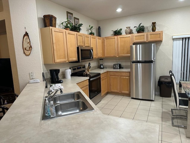 446 Summer Place Loop, Clermont, FL 34714 - kitchen featuring stainless steel appliances, a sink, light countertops, light tile patterned flooring, and a textured wall