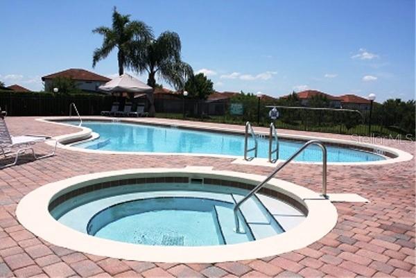 446 Summer Place Loop, Clermont, FL 34714 - community pool featuring fence, a hot tub, and a patio area