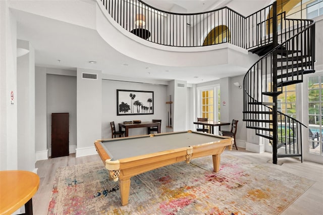 recreation room featuring wood finished floors, billiards, baseboards, and a towering ceiling