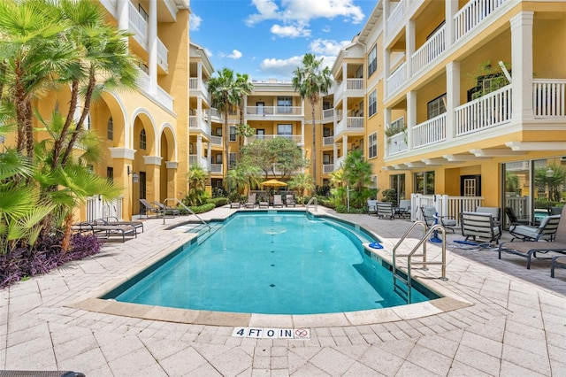 community pool with a patio area