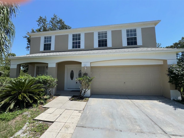 3707 Andover Cay Blvd, Orlando, FL 32825 - view of front of property featuring stucco siding, concrete driveway, and a garage