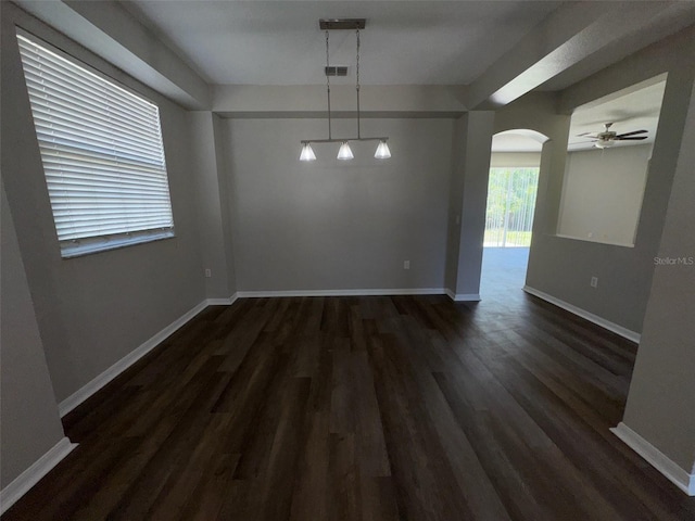 3707 Andover Cay Blvd, Orlando, FL 32825 - unfurnished dining area featuring dark wood-style flooring, arched walkways, a ceiling fan, and baseboards