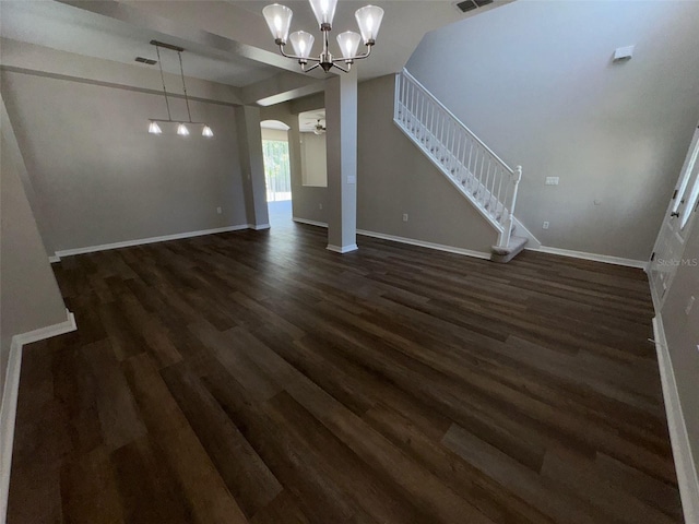 3707 Andover Cay Blvd, Orlando, FL 32825 - unfurnished living room featuring arched walkways, dark wood-style flooring, a chandelier, and baseboards
