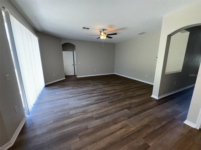 3707 Andover Cay Blvd, Orlando, FL 32825 - unfurnished room featuring arched walkways, ceiling fan, a textured ceiling, healthy amount of natural light, and dark wood-style flooring