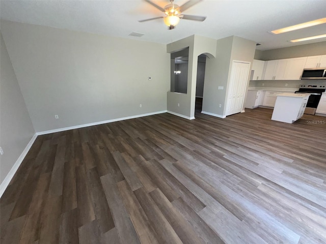 3707 Andover Cay Blvd, Orlando, FL 32825 - unfurnished living room with a ceiling fan, dark wood-type flooring, arched walkways, and baseboards