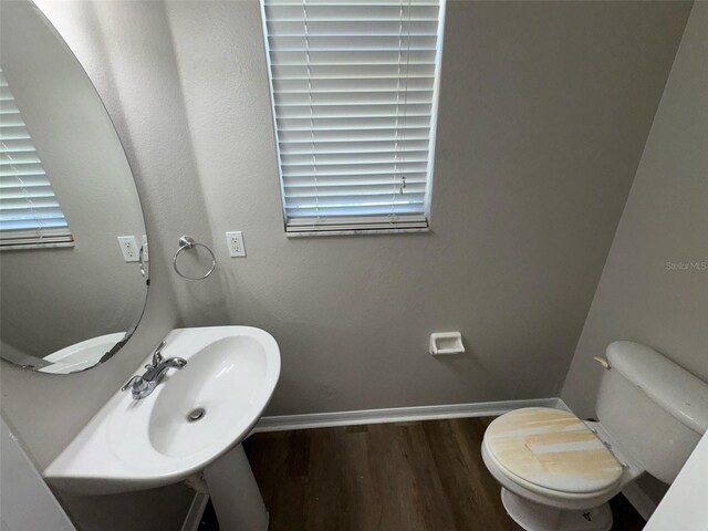3707 Andover Cay Blvd, Orlando, FL 32825 - bathroom featuring toilet, wood finished floors, and baseboards