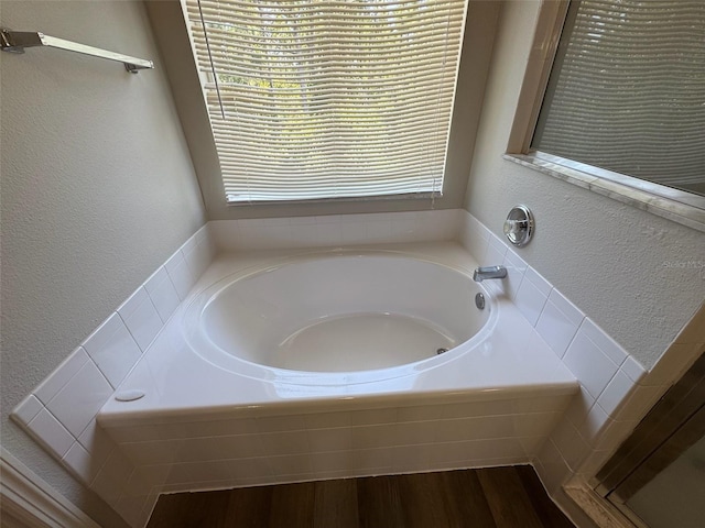 3707 Andover Cay Blvd, Orlando, FL 32825 - full bath with a garden tub, a textured wall, and wood finished floors