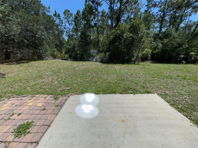 3707 Andover Cay Blvd, Orlando, FL 32825 - view of green lawn with a patio