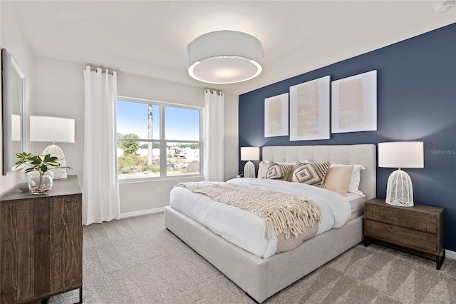 carpeted bedroom featuring baseboards