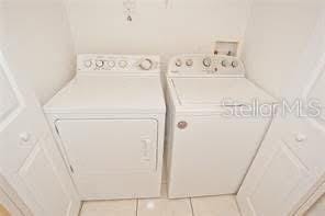 washroom featuring independent washer and dryer and tile patterned floors