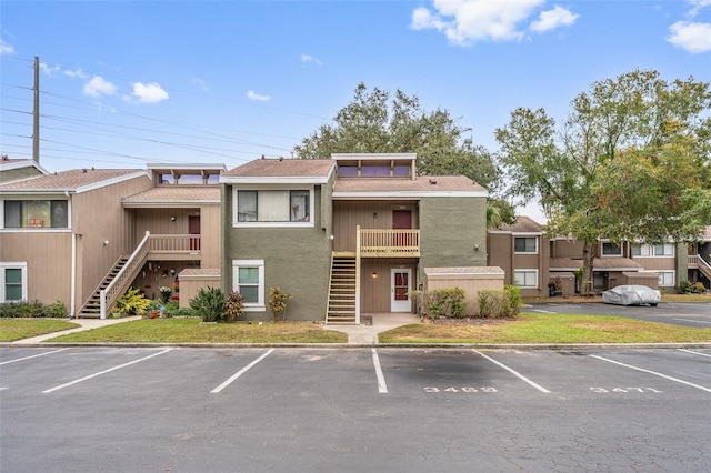 5071 Eaglesmere Dr Unit C01, Orlando, FL 32819 - view of building exterior with stairs and uncovered parking