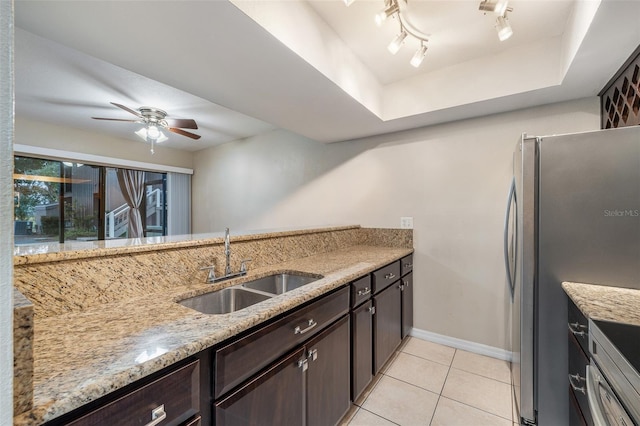 5071 Eaglesmere Dr Unit C01, Orlando, FL 32819 - kitchen featuring a sink, dark brown cabinets, ceiling fan, light tile patterned floors, and baseboards