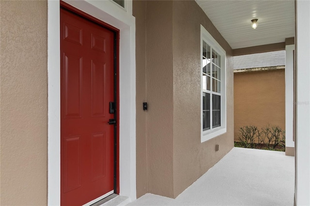 7551 Bear Claw Run, Orlando, FL 32825 - view of exterior entry featuring covered porch and stucco siding
