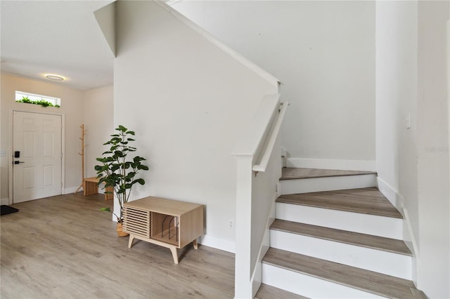 7551 Bear Claw Run, Orlando, FL 32825 - stairs with wood finished floors and baseboards