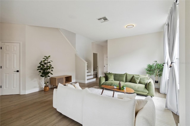 7551 Bear Claw Run, Orlando, FL 32825 - living room with wood finished floors, stairway, and baseboards