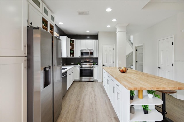 7551 Bear Claw Run, Orlando, FL 32825 - kitchen featuring open shelves, stainless steel appliances, wood counters, light wood-type flooring, and recessed lighting