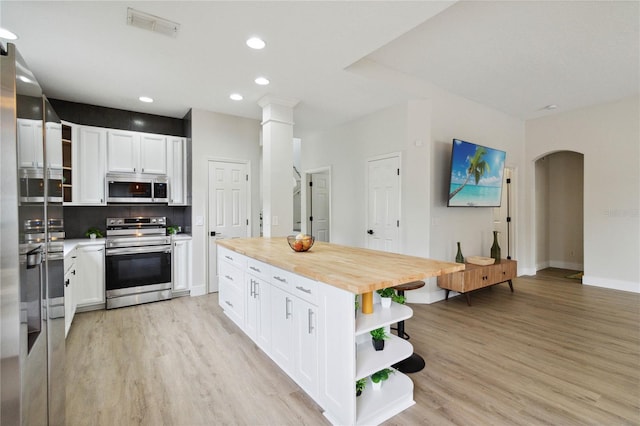 7551 Bear Claw Run, Orlando, FL 32825 - kitchen featuring open shelves, stainless steel appliances, butcher block countertops, white cabinetry, and recessed lighting