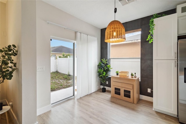 7551 Bear Claw Run, Orlando, FL 32825 - dining space with light wood-style flooring and baseboards