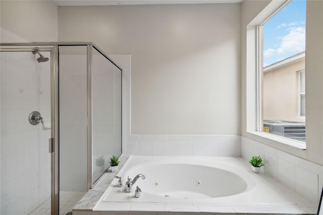 7551 Bear Claw Run, Orlando, FL 32825 - bathroom featuring a stall shower and a tub with jets