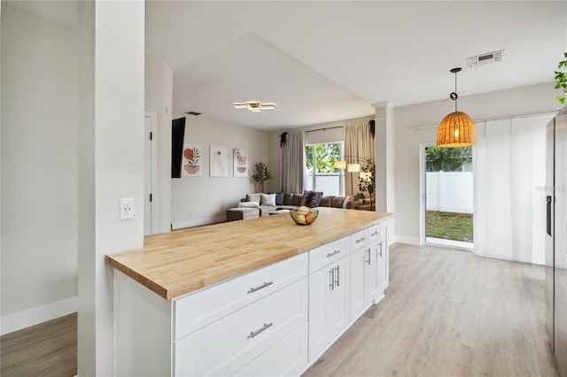 7551 Bear Claw Run, Orlando, FL 32825 - kitchen with butcher block countertops, open floor plan, light wood finished floors, and baseboards