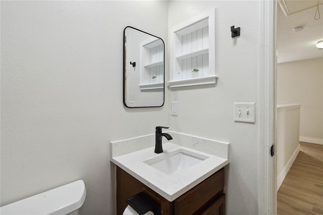 7551 Bear Claw Run, Orlando, FL 32825 - half bathroom featuring toilet, vanity, and wood finished floors