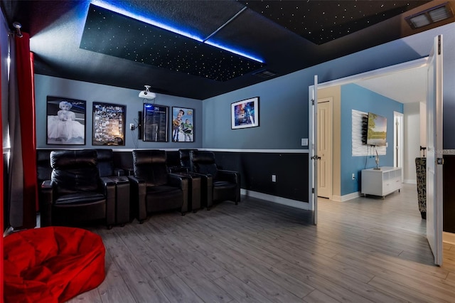 cinema room with wood finished floors and baseboards