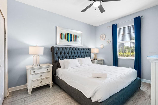 bedroom featuring wood finished floors, baseboards, and ceiling fan