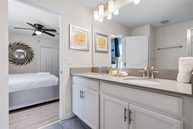 bathroom featuring ceiling fan, double vanity, and tile patterned flooring