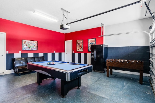 recreation room with concrete block wall and pool table