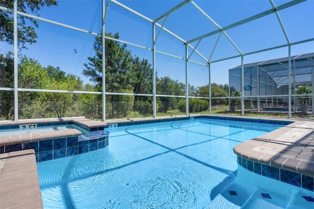 view of swimming pool with a lanai and a pool with connected hot tub