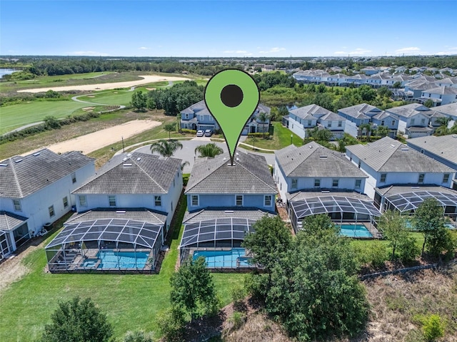 aerial perspective of suburban area featuring a pool and a golf course